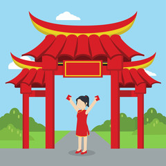 chinese woman holding hang bao in front of chinese gate