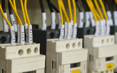 Close-up electrical wiring with fuses and contactors of machine controller.