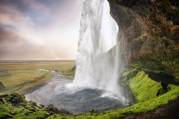 Seljalandsfoss, Iceland - Passage under the waterfall with rainb