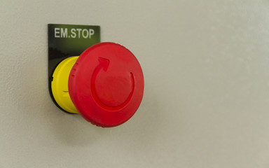 Red emergency stop and reset on control panel.