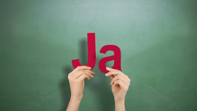 Woman hand holding letters J and A
