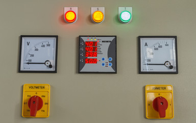 Volt and amp meter switching button on electric control panel.