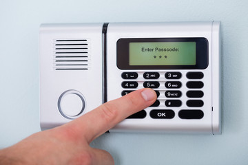 Person's Finger Entering Code In Security System