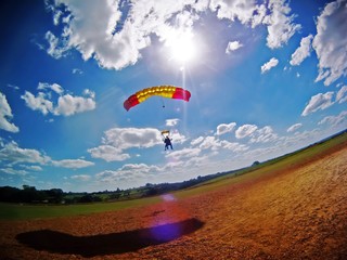 Parachute tandem landing with lens flare