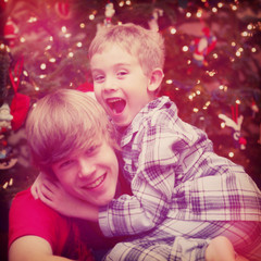 Fototapeta na wymiar Happy Brothers in front of a christmas tree. Instagram effect