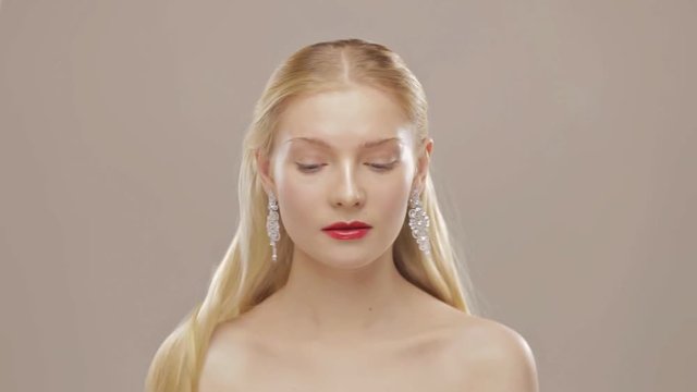 Gorgeous blond girl with falling hair in slow motion