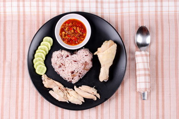 Streamed red brown oily rice and streamed chicken .