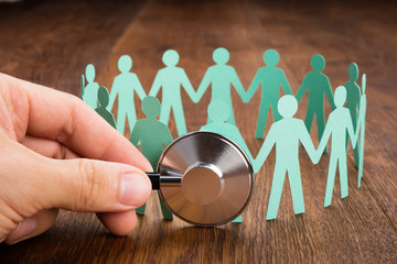 Person Using Stethoscope On Papercut