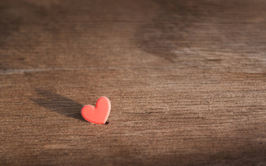  red hearts on old wooden floors with light and shadow.