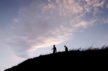 Fototapeta premium Silhouette of people walking on the hill at mountain