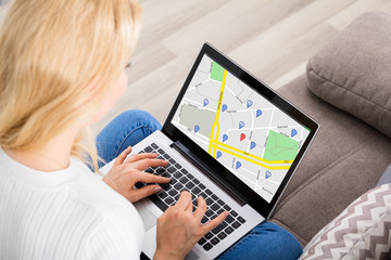Woman Browsing GPS Map On Laptop