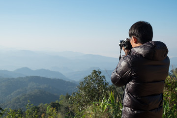 Young professional traveler man with camera shooting outdoor, fa
