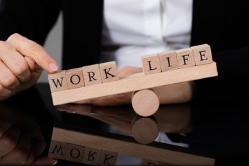 An Imbalance Between Life And Work On Seesaw