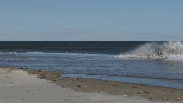 large wave and foam crashing on beach
