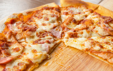 pizza slices on wooden plate
