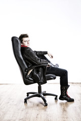 Handsome guy sits in a chair on a white background