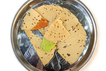 Overhead photo of Indian bread with traditional sauces