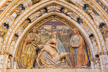 Fototapeta na wymiar SEGOVIA, SPAIN, APRIL - 14, 2016: The relief of pieta on the portal in atrium of the Cathedral by Juan Guas (1483).