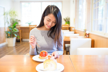 Woman enjoy in cake shop