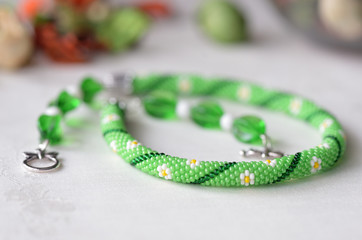 Beaded crochet choker necklace with flower print close up