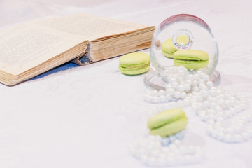 Beautiful composition with french dessert next to a pearl beads