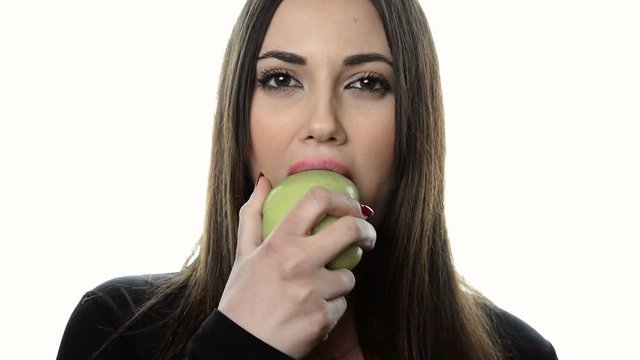 Pretty brunette young woman eating apple  