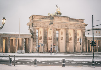 Brandenburg gate (Brandenburger Tor) and 18th of March Square in snow, Berlin, Germany, Europe, Retro filtered style