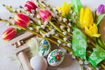 Traditional Czech easter decoration - regional wooden ratchet instrument with painted  eggs with...