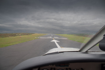 Fototapeta na wymiar Cockpit view from a light aircraft on runway 32 of the St Mary's Airport on the Isles of Scilly.