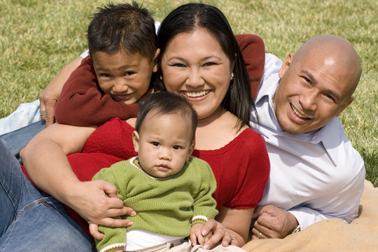 Loving Asain Parents And Their Smiling Children.