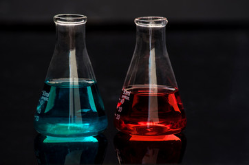 Laboratory tools , conical flasks containing colored solutions