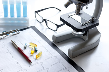 doctors desk with microscope and test tubes