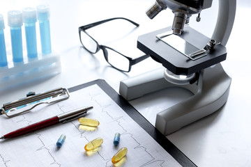 doctors desk with microscope and test tubes