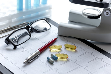 doctors desk with microscope and test tubes