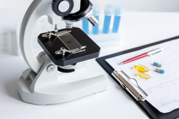 doctors desk with microscope and test tubes