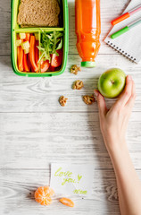 kid menu lunchbox for school top view on wooden background