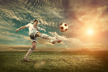 Fototapeta na wymiar Soccer player with ball in action outdoors.