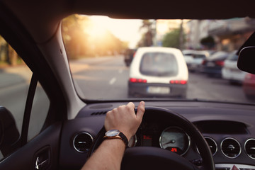 Driving a car through the city streets on a sunny day
