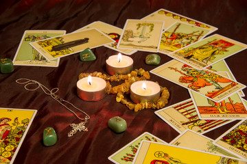 Tarot cards with runes and burning candle