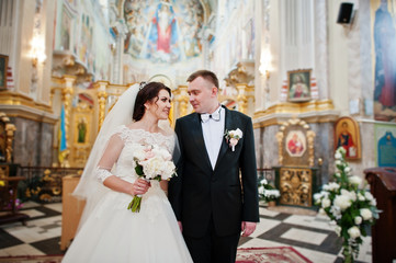 Happy smiled wedding couple after wedding registration on church