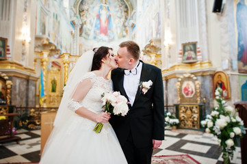 Happy smiled wedding couple after wedding registration on church