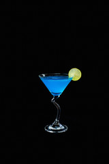 Blue alcohol cocktail with lemon slice isolated on black backgro