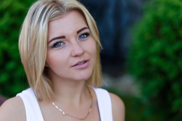 Portrait of a beautiful blonde outdoors in summer