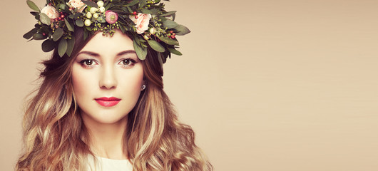 Beautiful blonde woman with flower wreath on her head. Beauty girl with flowers hairstyle. Perfect...