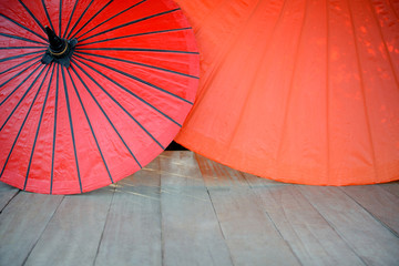 Red umbrella on a wooden floor