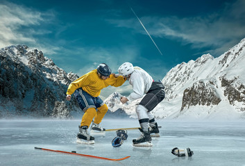 Ice hockey player in action outdoor around mountains