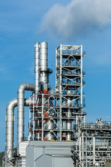 Refinery tower in petrochemical industrial plant with cloudy sky