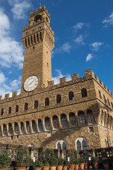 Obraz premium Fragment of clock tower of the Old Palace with blue sky. Tuscany. Italy.