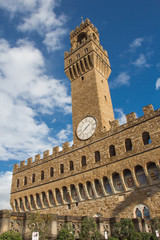 Obraz premium Fragment of clock tower of the Old Palace with blue sky. Tuscany. Italy.