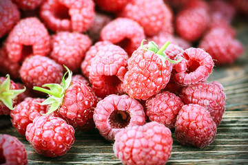 fresh raspberry on a wooden table. Soft focus